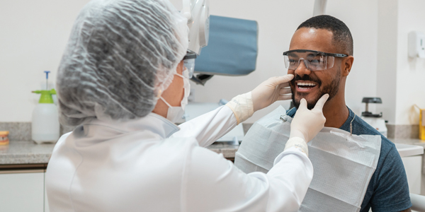 man in dental chair 600x300