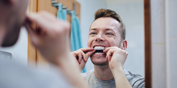 man whitening in mirror 600x300
